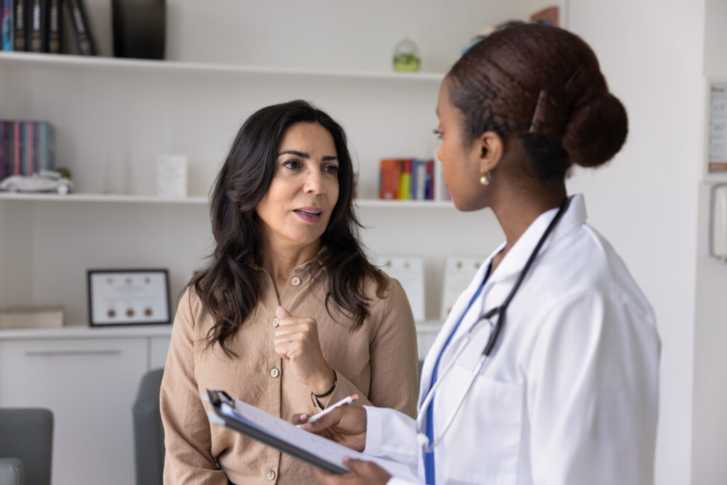 Doctor listening attentively to a patient during a consultation to improve patient experience and communication.